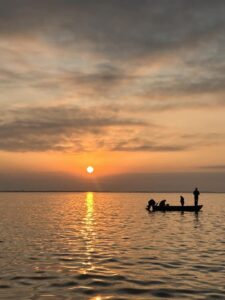 Silhouette of a fishing boat on open water